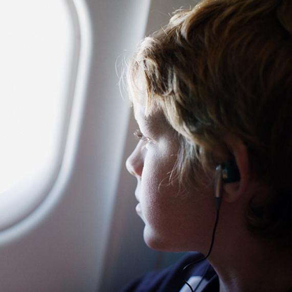 Lad looking out of aeroplane window